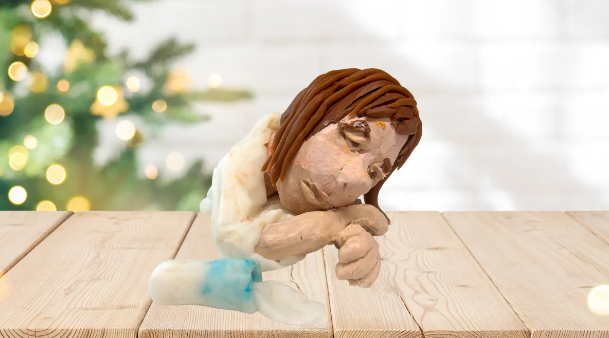 Kuvituskuva, jossa muovailuvahasta tehty väsynyt ihmishahmo ja pöydälle kaatunut maitolasi.