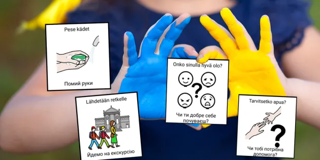 Hoitaja pitelee käsissään suomi-ukraina -kuvakortteja.